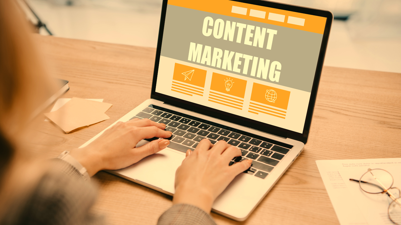 Partial view of businesswoman typing on laptop with Content Marketing at workplace